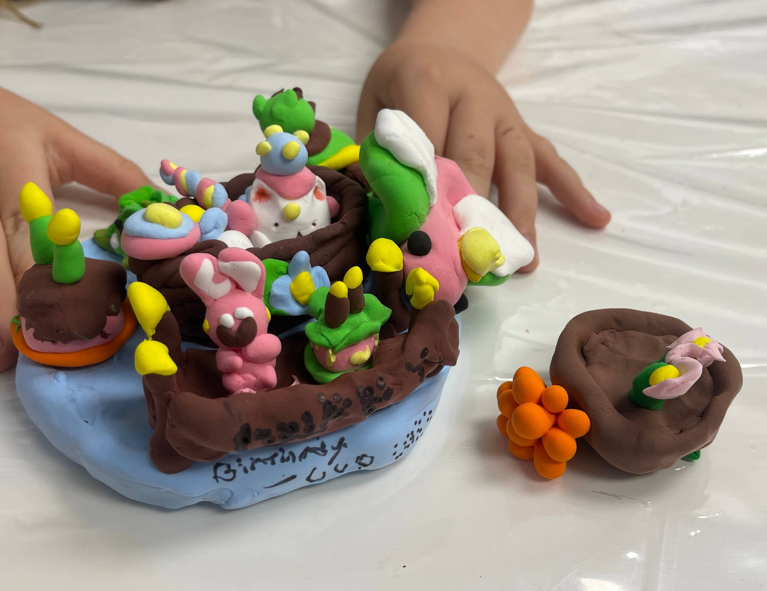 Students ages 5–7 explored clay modeling
